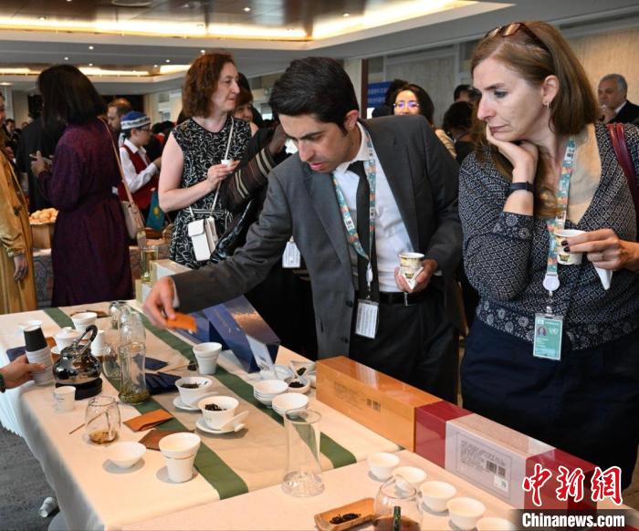 現(xiàn)場(chǎng)觀眾觀看中國(guó)展臺(tái)茶藝表演、了解茶文化?！【笜?攝