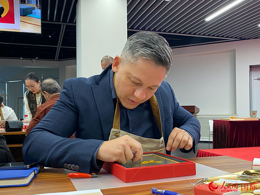 2023“一帶一路”媒體合作論壇聯(lián)合采訪團(tuán)團(tuán)員，親身體驗(yàn)景泰藍(lán)工藝。人民網(wǎng)記者 于洋攝