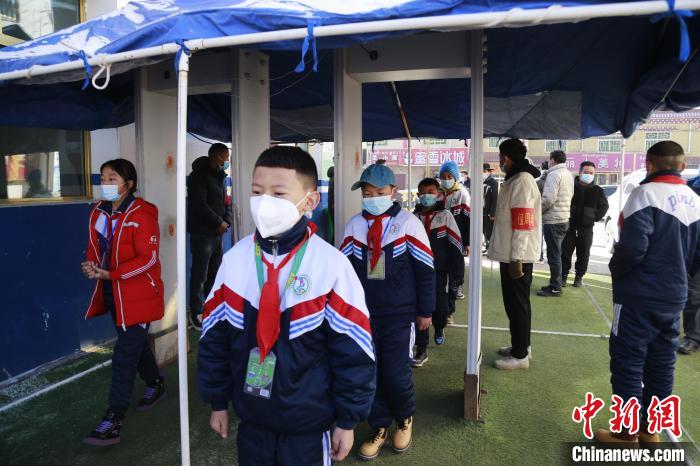 圖為學生測量體溫后進入校園?！●R銘言 攝