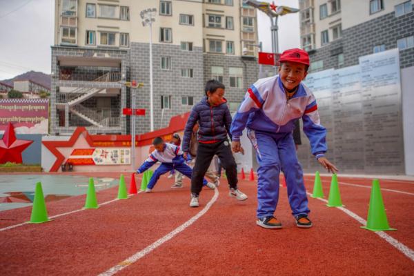 在高原上教孩子們打手球，“慢慢兒來，甭著急！”