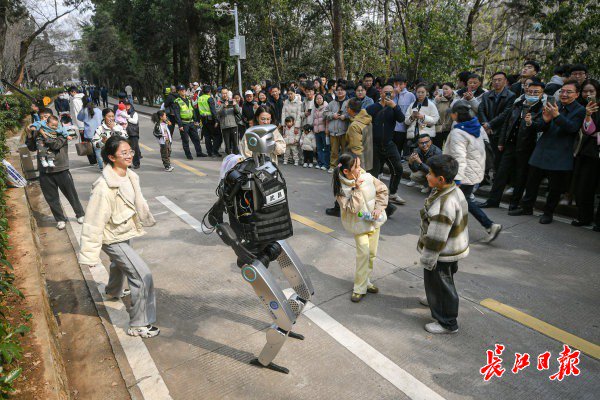 “智警小珞”人形機(jī)器人和小朋友們斗舞。長江日報(bào)記者史偉 攝