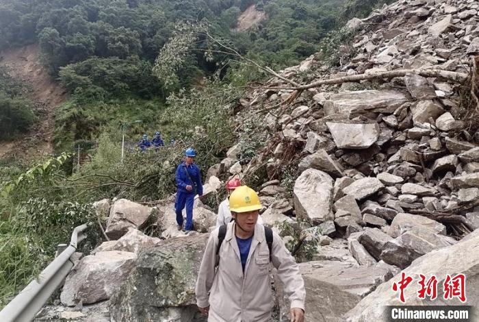 電力搶險(xiǎn)人員徒步通過(guò)垮塌路段?！∷拇娏﹫D