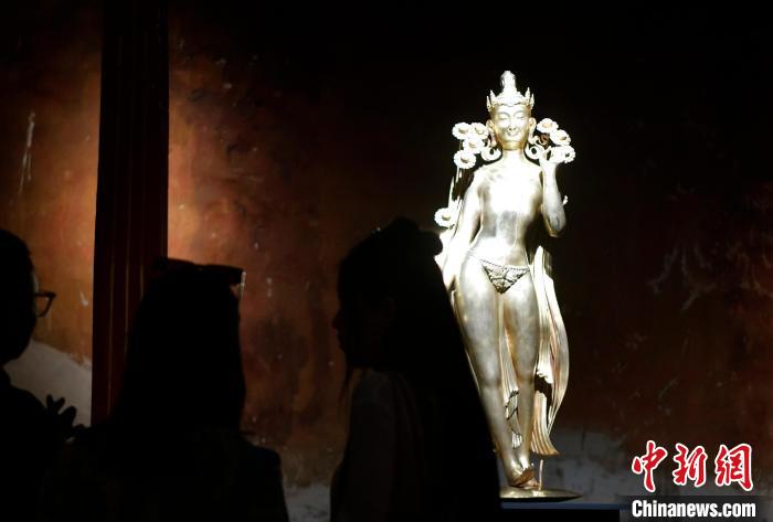 圖為觀眾正在欣賞展覽中的雕塑作品《八萬四千年》?！±盍?攝